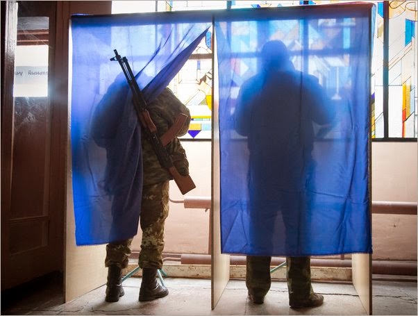 Helping international “observers” see armed men at “polling stations” in the Donbas