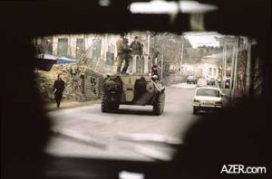 Soviet armored troop carriers patrolling streets in Baku during the week of January 20, 1990. The photographer had to take this photo covertly through a car windshield, because it was too dangerous to openly photograph the Black January events. Photo: Reza.