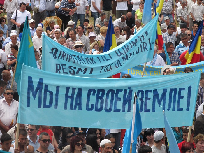 Crimean Tatar protest. The sign in Russian reads: "We are on our own land!"
