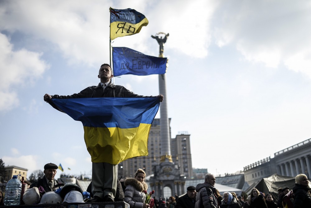 A young man holding the Ukrainian flag at the Maidan on February 24, 2014 (Image: Bulent Kilic / AFP)