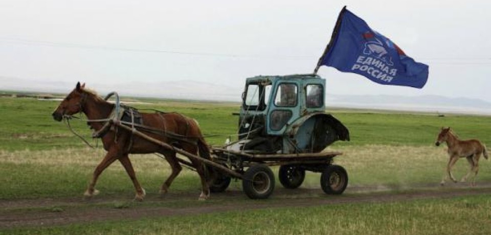 Putin's United Russia party campaigning in a Russian village: the horse-drawn cart reusing the cabin from a dismantled tractor prominently displays its flag wherever it goes (Image: rufabula.ru)