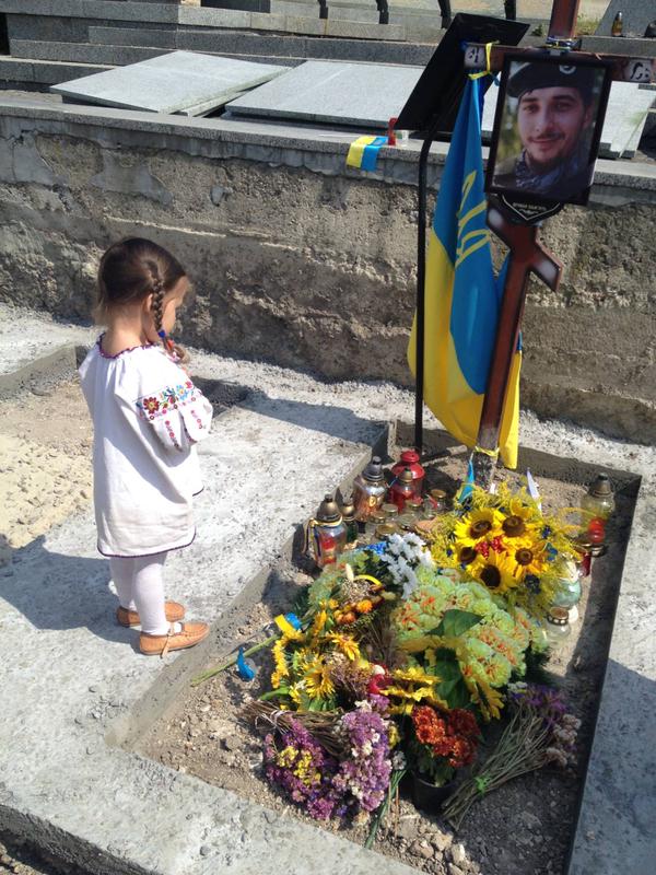 Yustinka, daughter of Victor Gurnyak killed defending Ukraine from the Russian aggression, at her father's grave. Eternal memory to all Ukraine's heroes who gave their lives defending Ukraine. (Image: social media)