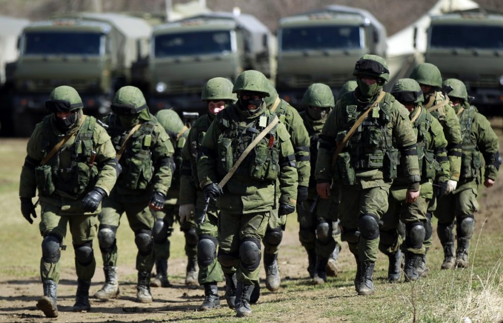 So-called "little green men" (the Russian occupation troops comprised of special forces who removed insignia, wear face masks to prevent identification and call themselves a "Crimean self-defense force") surround a Ukrainian military base in Perevalne, Crimea, during the Russian annexation of the peninsula in February-March 2014.
