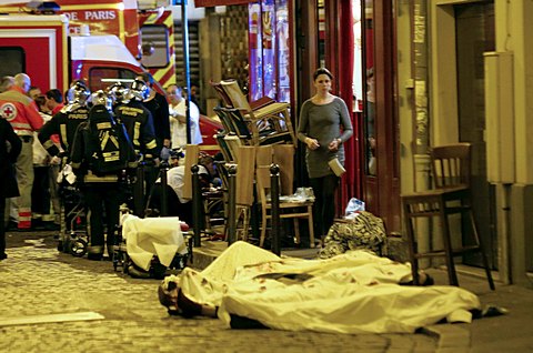 A woman watches victims in the 10th district of Paris, Friday, Nov. 13, 2015. (AP Photo/Jacques Brinon)