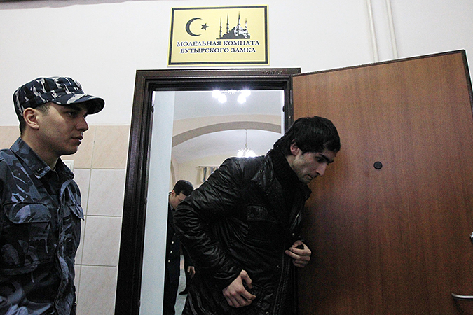 Prisoner being escorted out of the Muslim prayer room at Butyrka, the largest remand prison in Moscow, Russia (Image: mk.ru)