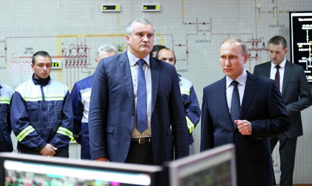 Putin with the head of the Russian occupation administration Sergey Aksyonov launching the first underwater power cable from Russia to Crimea on December 2, 2015.