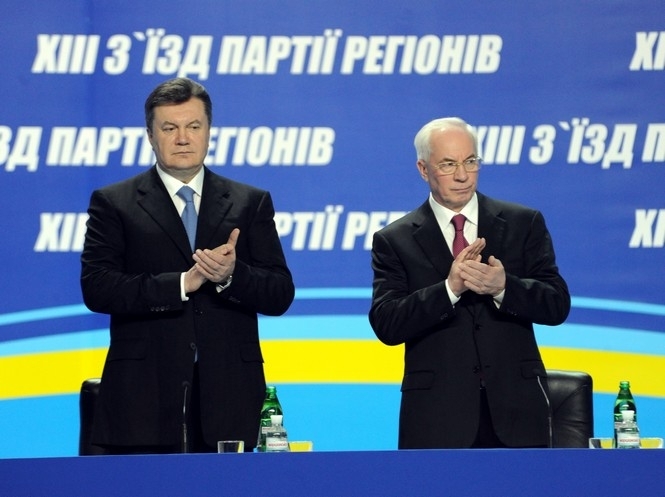 Disgraced Ukrainian president Yanukovych (left) stands next to Mykola Azarov (right) at the 13th congress of their Kremlin-allied Party of Regions