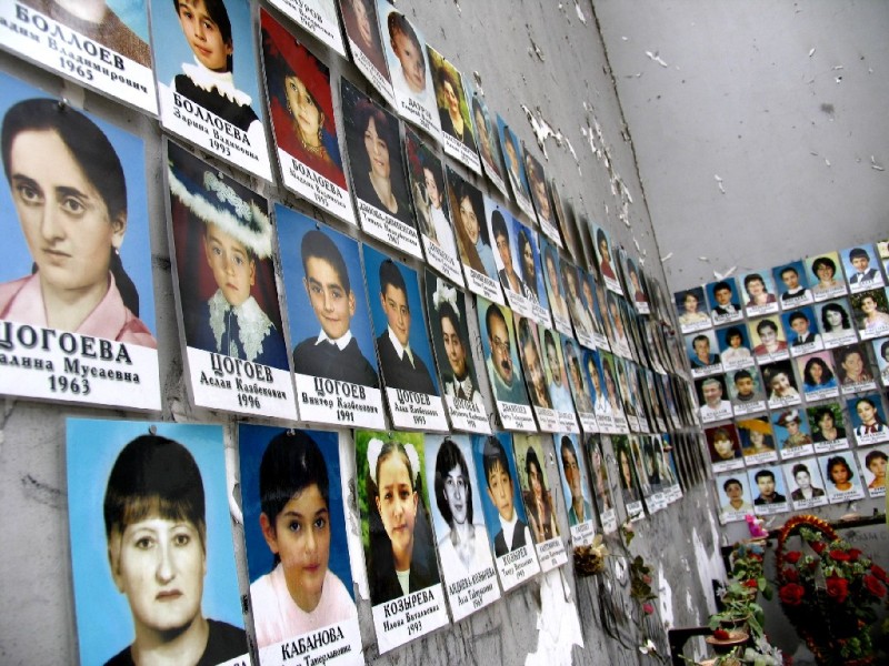 Photos of the killed hostages line up the walls of the Beslan School #1. The European Court for Human Rights has concluded that the Russian troops were responsible for killing the hostages in 2004, not terrorists, as Putin government portrayed it. Over 330 hostages were killed in the massacre, including 186 children. (Image: Wikipedia)