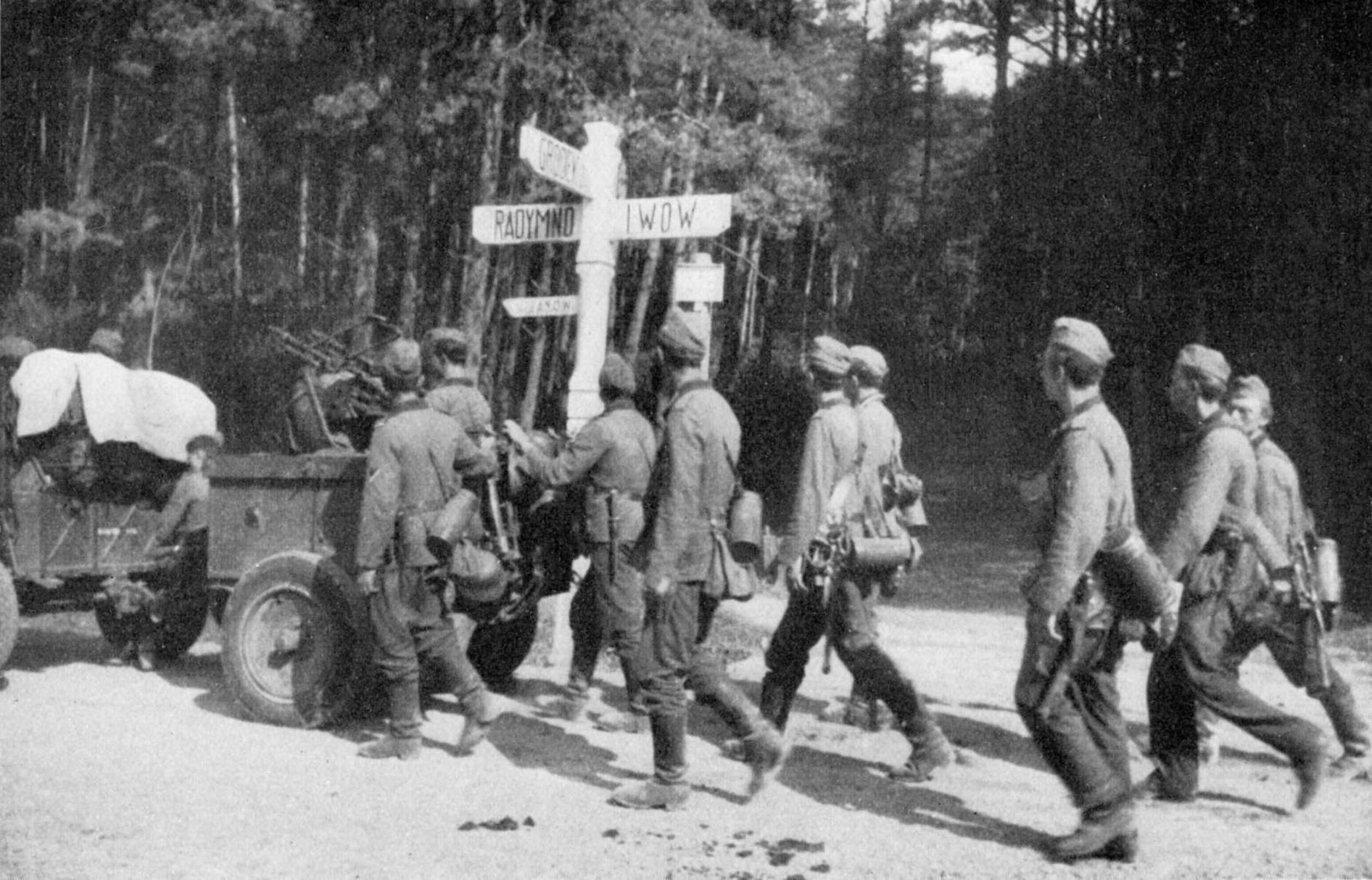 Invading German troops marching past a road sign near Lviv, 1939