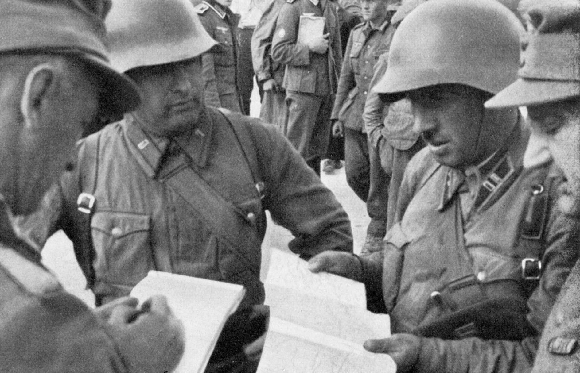 Russian and German commanders in discussion over a map of Poland, 1939 (imgur.com)