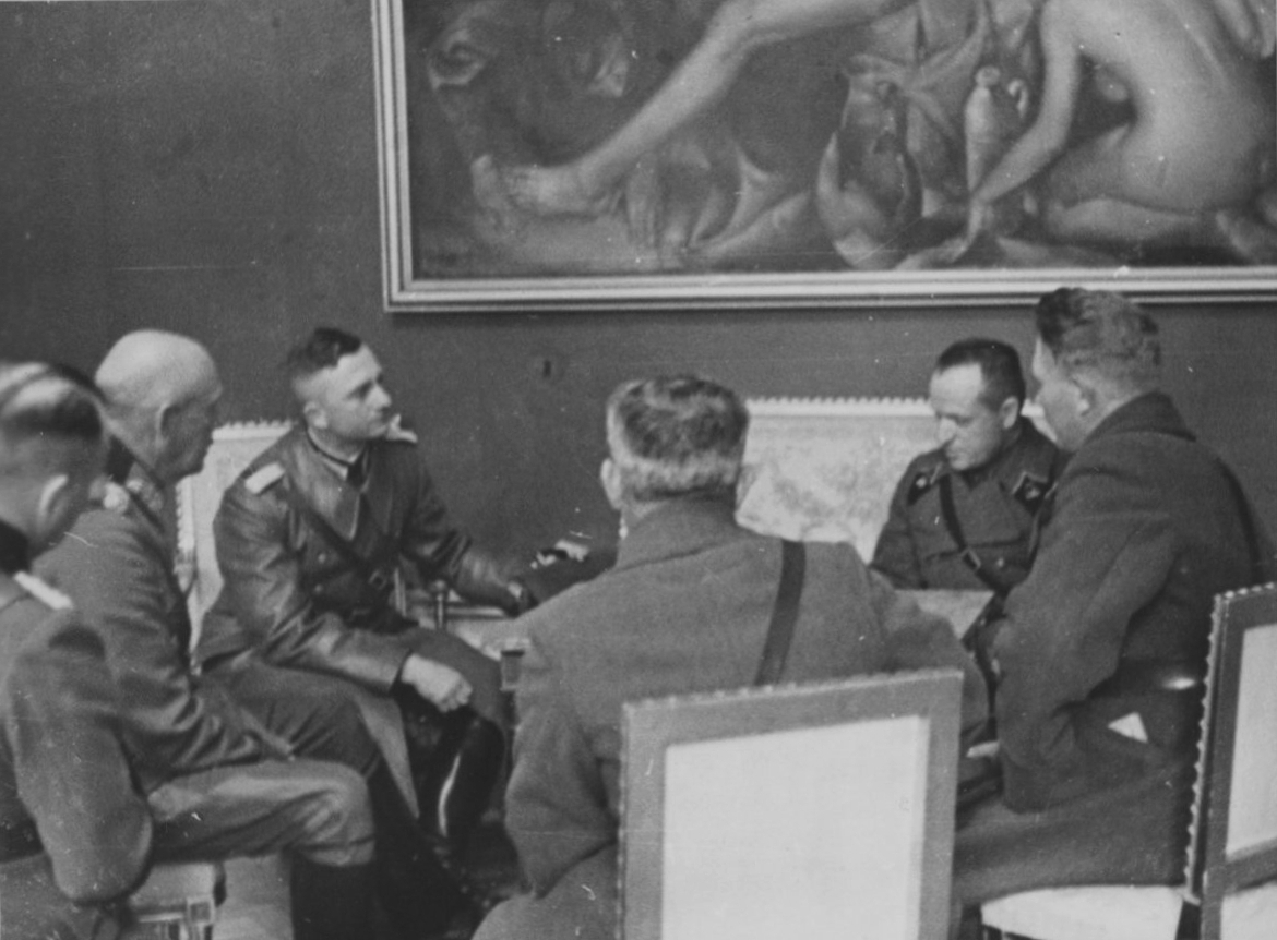 German (L) and Soviet (R) commanders in Poland discuss the Soviet-Nazi demarcation on a map of the conquered country in September 1939. At the time, German troops advanced farther than was agreed in the Molotov-Ribbentrop Pact and had to cede the extra territory to the Soviets.