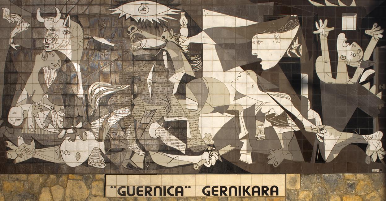 Mural of the painting "Guernica" by Picasso depicting the carpet bombing of the Basque town of Guernica during the Spanish Civil War. It was carried out at the behest of the Spanish nationalist government by its allies, the Nazi German Luftwaffe's Condor Legion and the Fascist Italian Aviazione Legionaria, under the code name Operation Rügen on 26 April 1937. The attack gained infamy because it involved the deliberate targeting of civilians by a military air force, just as it was done by the Russian and Syrian government military air forces in Aleppo. Location: Guernica, Spain (Image: Papamanila via Wikipedia)