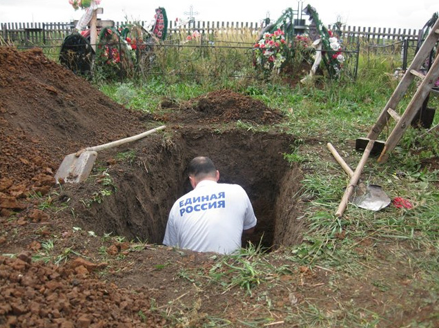 The grave digger wearing a t-shirt of Russia's ruling party "United Russia." (Image: social media)
