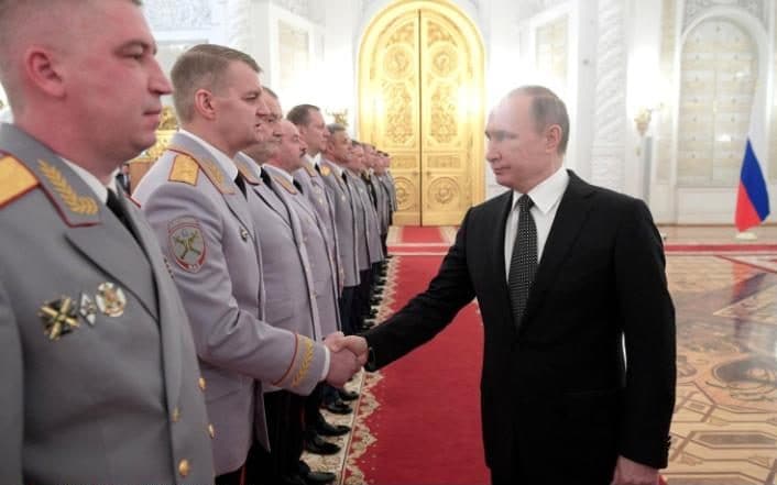 Russian President Vladimir Putin greets Russian military and security services generals during a promotion ceremony at the Kremlin in Moscow (Image: Planet Pix/Rex/Shutterstock)