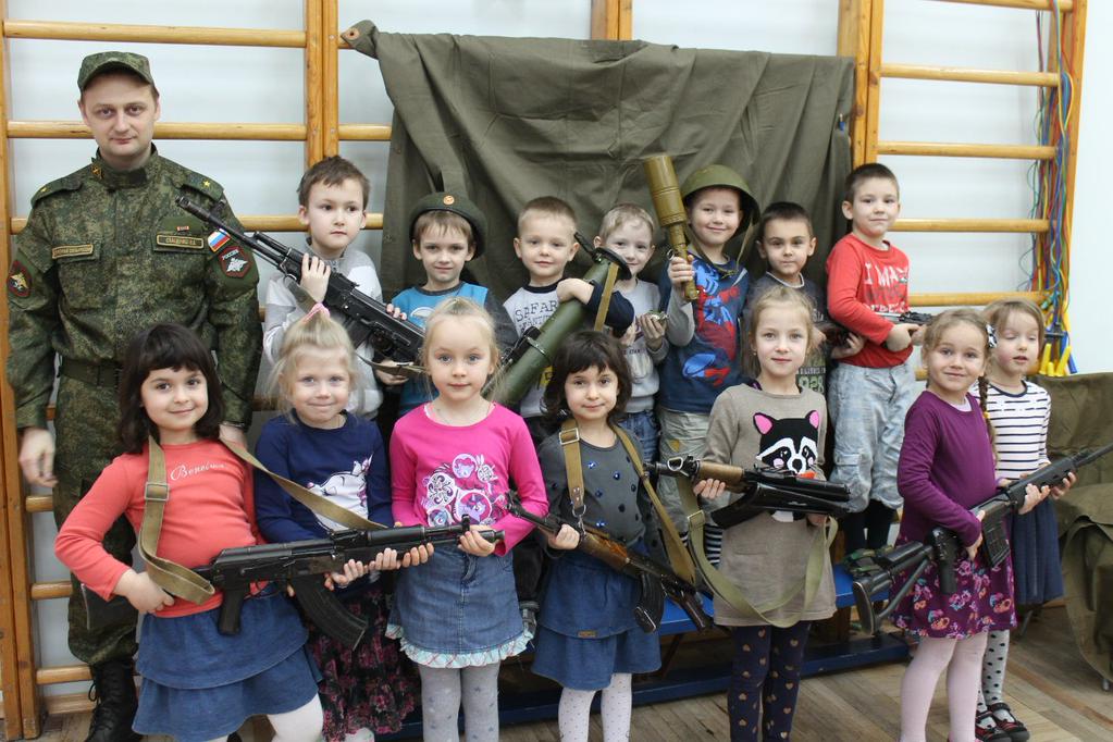 Russian kindergarten children holding Kalashnikov assault rifles, grenades and grenade launchers after a "patriotism" lesson in St. Petersburg, Russia, February 2015 (Image: social media)
