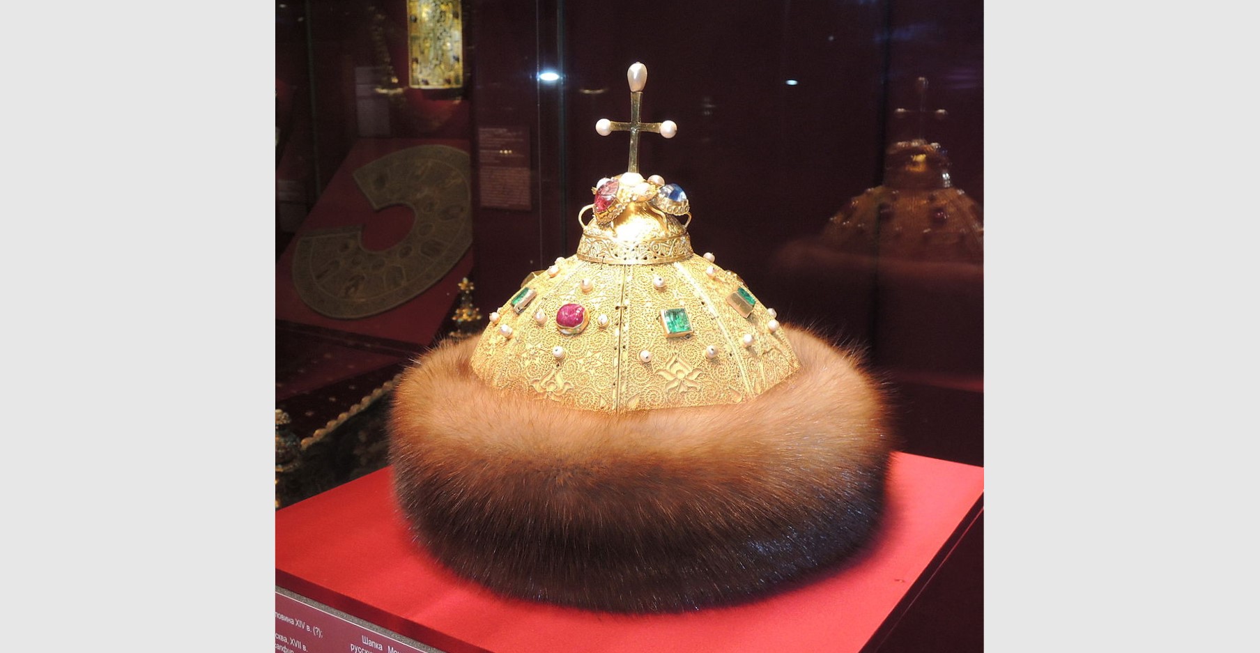 Monomakh's Cap is a chief relic of the Muscovy Grand Princes and Tsars. It is a symbol-crown of their autocracy, and is the oldest of the crowns currently exhibited at the Kremlin Armoury. Monomakh's Cap is an early 14th-century gold filigree skullcap composed of eight sectors, ornamented with a scrolled gold overlay, inlaid with rubies, emeralds and pearls, and trimmed with sable. The cap is surmounted by a gold cross with pearls at each of the extremities. (Photo: Shakko via Wikipedia)