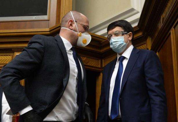 Prime Minister Denys Shmygal and Head of Parliament Dmytro Razumkov talking before the voting. They and all people's deputies came to the Parliament in masks due to corona virus.