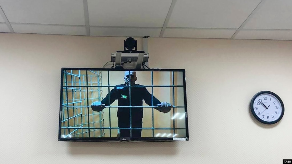 Russian opposition leader Aleksei Navalny currently imprisoned by the Putin regime is seen on a screen via a video link during a court hearing in June, 2021. (Photo: TASS)