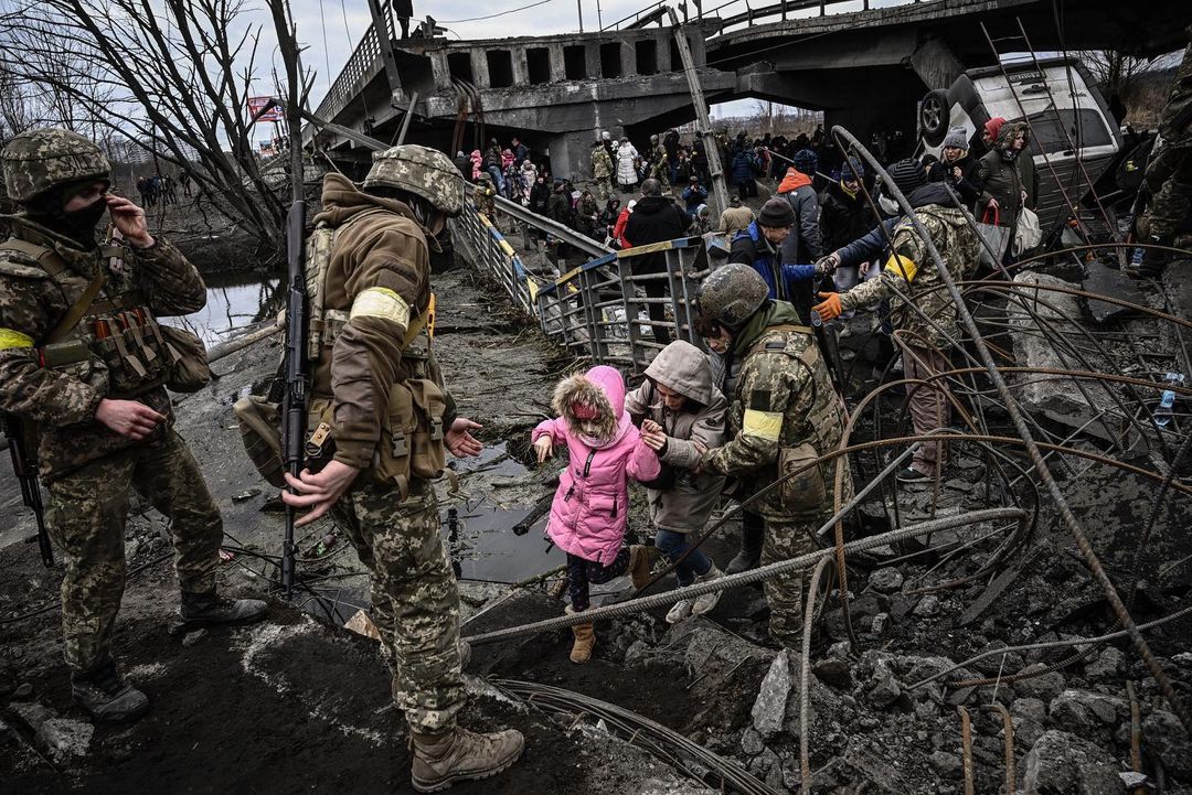 Ukrainian civilians are evacuated from the city of Irpin, northwest of Kyiv, during heavy Russian shelling and bombing. Photo by Aris Messinis. 5 March 2022. ~