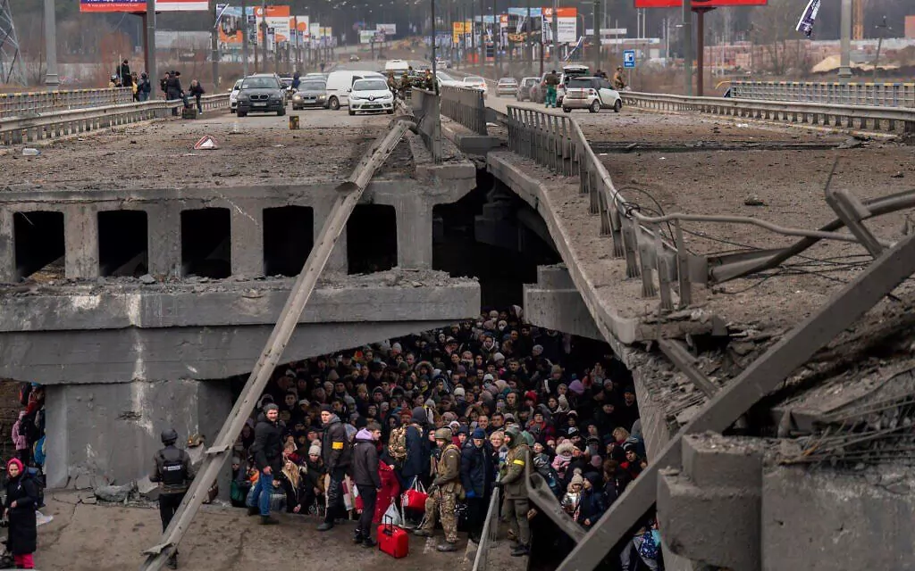 People who are trying to evacuate from Russian-occupied Irpin hide from the Russian mortar fire under the collapsed bridge. 5 March 2022. Source. ~