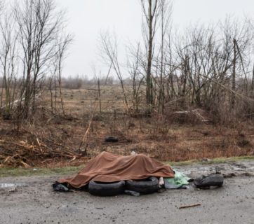 Dead civilians are seen near a highway 20 km outside of Kyiv. Under the blanket are 4-5 dead naked women whom Russian soldiers tried to burn right there on the side of the road. Photo by Mikhail Palinchak. Source: Ministry of Defense of Ukraine. 2 April 2022