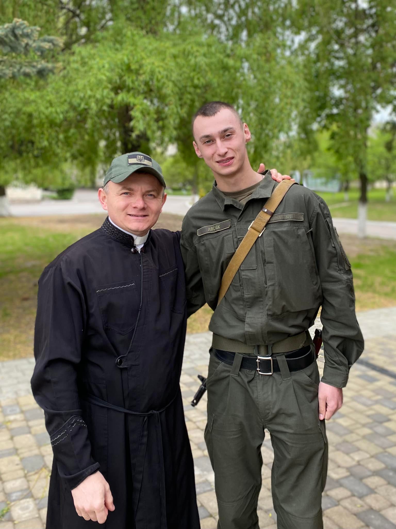 Father Andriy Sidanych with a serviceman of the National Guard of Ukraine ~