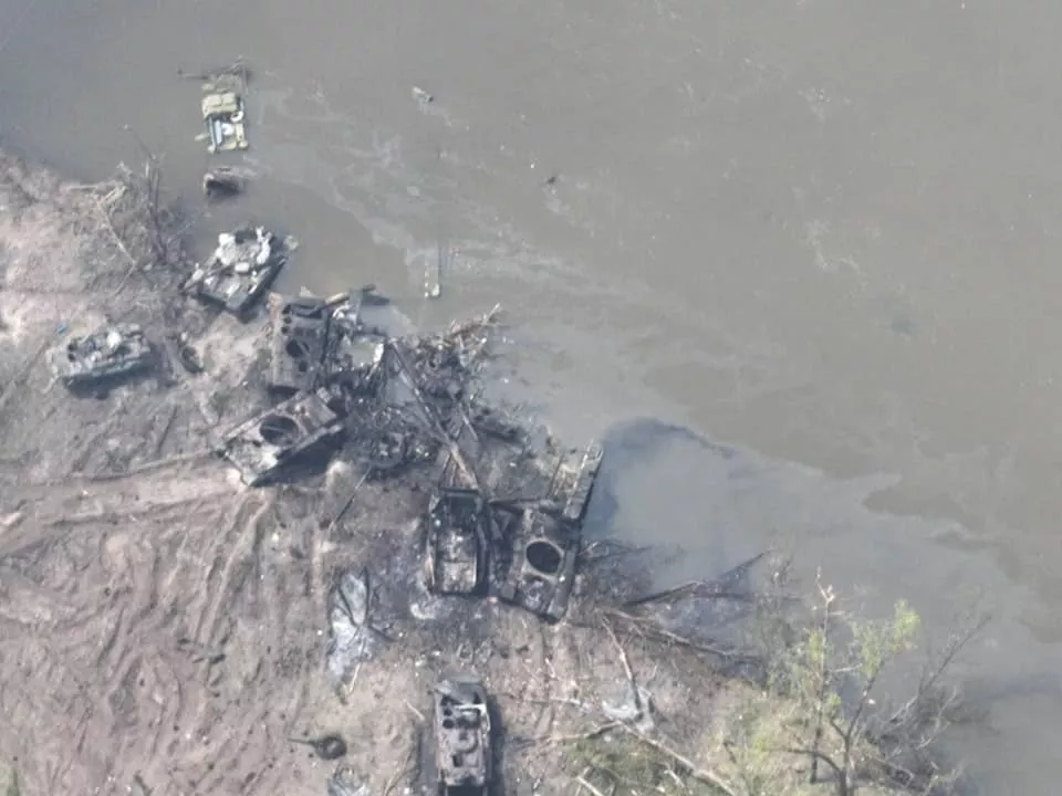 Wreckage of the Russian infantry fighting vehicles and tanks on the Ukraine-controlled bank of the Siverskyi Donets River, destroyed by the Ukrainian artillery and aircraft amid the Russian attempt at crossing the river near Bilohorivka. Source. ~