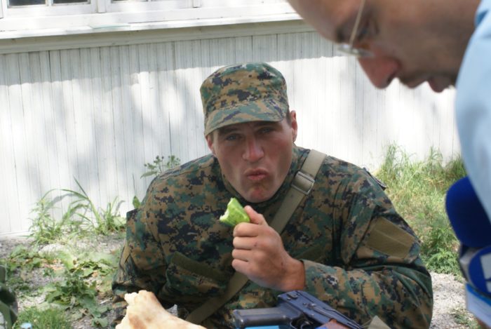 Russian soldier eats at checkpoint during the invasion of Georgia