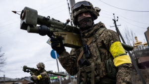 Ukrainian soldier holds weapon