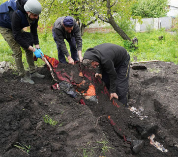 police and volunteers exhume bodies Stepaky village Kharkiv Oblast