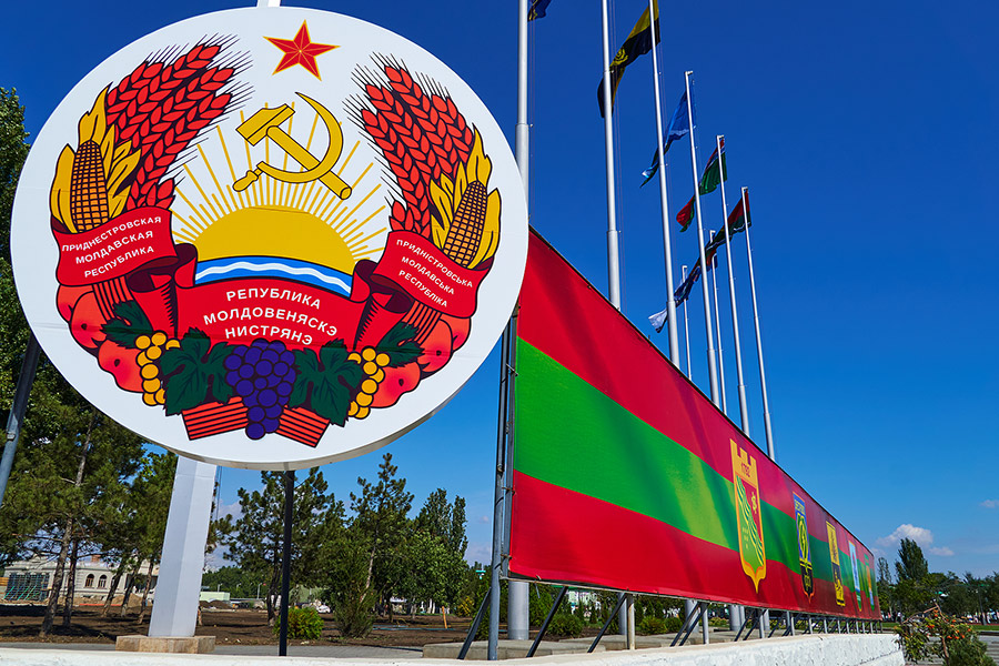 Transnistria state emblem and flags, downtown of the city Tiraspol, occupied Transnistria, Moldova. 25 August 2020. Photo: emerging-europe.com ~