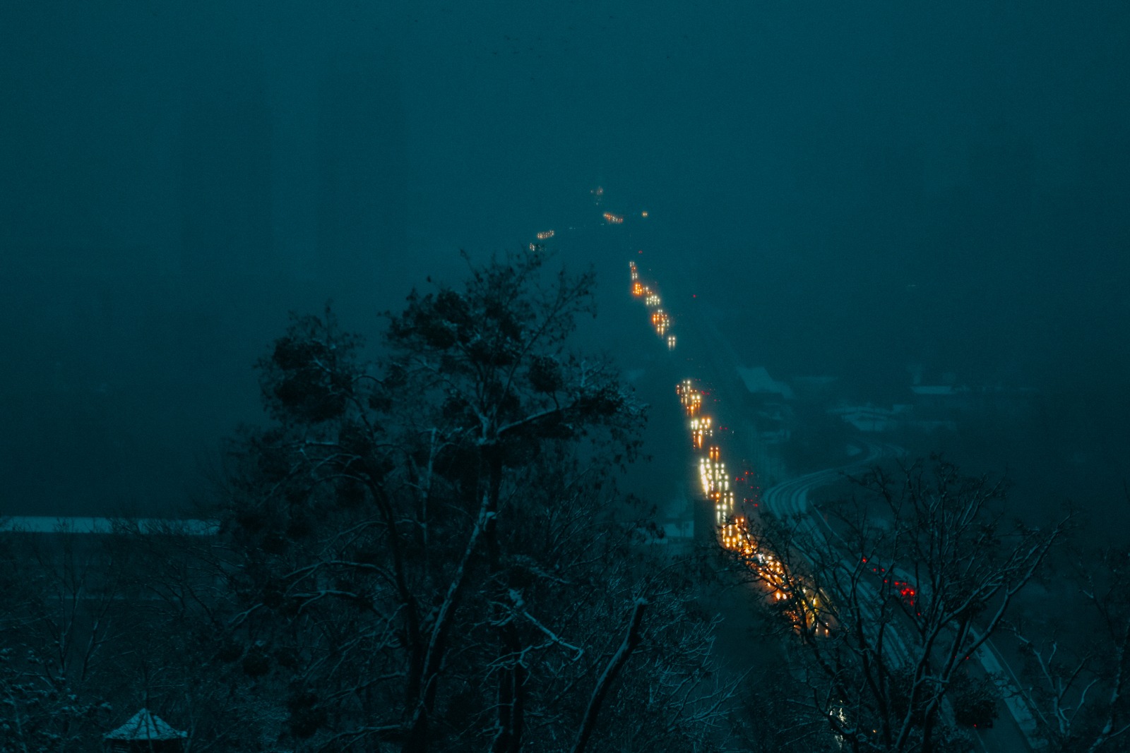Cars move in the dark during electricity cuts off in Kyiv. Image by Serhii Ristenko